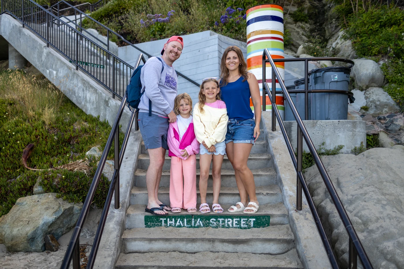 Erica and Zach Stoltz with their daughters on the Thalia Street steps